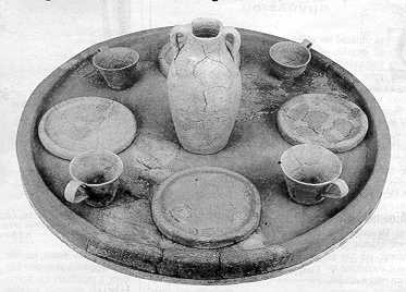 A clay tray & dishes, cups, a vase